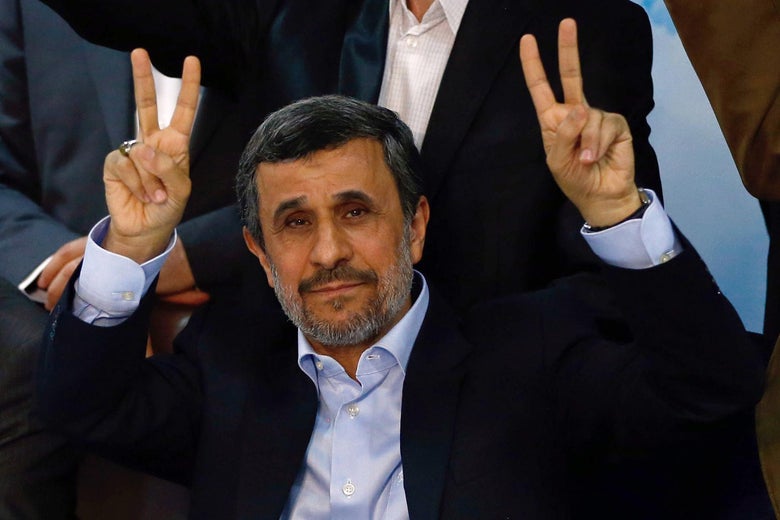 Former Iranian president Mahmoud Ahmadinejad (C) flashes the sign for victory at the Interior Ministry's election headquarters as candidates begin to sign up for the upcoming presidential elections in Tehran on April 12, 2017.Ahmadinejad had previously said he would not stand after being advised not to by supreme leader Ayatollah Ali Khamenei, saying he would instead support his former deputy Hamid Baghaie who also registered on Wednesday.